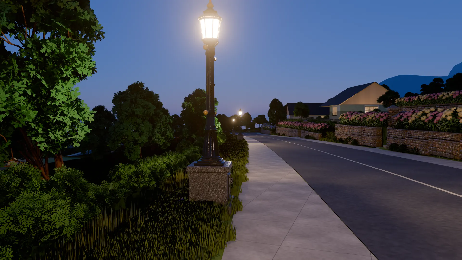 A street lamp lit at blue hour beside a curving road, gardens and houses along the wall beyond.